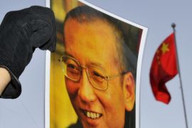 A protester holds an image of to jailed dissident Liu Xiaobo outside of the Chinese Embassy in Oslo December 9, 2010. The Nobel Peace Prize panel on Thursday defended its award to jailed dissident Liu as based on