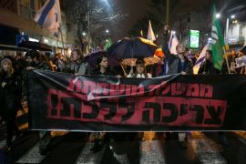 Left wing protesters march during a demonstration calling for the resignation of Israel's Prime Minister Benjamin Netanyahu over police investigations for suspected corruption, in Tel Aviv, Israel January 14, 2017. The banner reads
