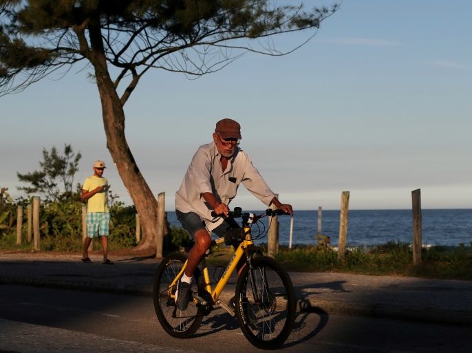 An elderly man rides his bicycle on Recreio dos Bandeirantes beach in Rio de Janeiro, Brazil June 29, 2017. REUTERS/Sergio Moraes