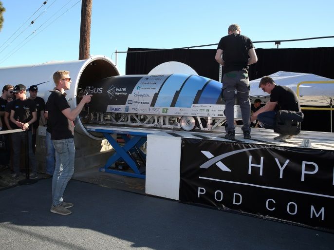 Team members from WARR Hyderloop, Technical University of Munich place their pod on the track during the SpaceX Hyperloop Pod Competition in Hawthorne, Los Angeles, California, U.S., January 29, 2017. REUTERS/Monica Almeida