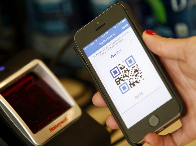 A PayPal employee demonstrates one of the company's options to pay with a mobile device at store within a PayPal office building in San Jose, California May 28, 2014. REUTERS/Beck Diefenbach (UNITED STATES - Tags: BUSINESS)