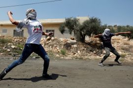 Palestinian protesters hurl stones at Israeli troops during clashes in the West Bank village of Kofr Qadom near Nablus August 11, 2017. REUTERS/Mohamad Torokman