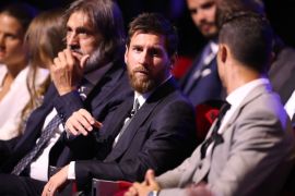 Real Madrid's Portuguese forward Cristiano Ronaldo (R) speaks with Barcelona's Argentinian forward Lionel Messi (C) as they wait ahead of the awarding of the title of 'Best Men's Player in Europe' at the conclusion of UEFA Champions League group stage draw ceremony in Monaco on August 24, 2017. / AFP PHOTO / VALERY HACHE (Photo credit should read VALERY HACHE/AFP/Getty Images)