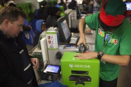 A man buys an XBOX One video game console at a Toys