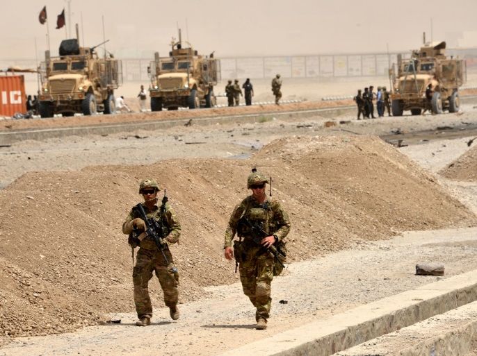US soldiers walk at the site of a Taliban suicide attack in Kandahar on August 2, 2017.A Taliban suicide bomber on August 2 rammed a vehicle filled with explosives into a convoy of foreign forces in Afghanistan's restive southern province of Kandahar, causing casualties, officials said. 'At around noon a car bomb targeted a convoy of foreign forces in the Daman area of Kandahar,' provincial police spokesman Zia Durrani told AFP. / AFP PHOTO / JAVED TANVEER (Photo credit should read JAVED TANVEER/AFP/Getty Images)