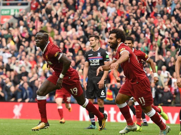 Liverpool's Senegalese midfielder Sadio Mane (L) celebrates after scoring the opening goal of the English Premier League football match between Liverpool and Crystal Palace at Anfield in Liverpool, north west England on August 19, 2017. / AFP PHOTO / Oli SCARFF / RESTRICTED TO EDITORIAL USE. No use with unauthorized audio, video, data, fixture lists, club/league logos or 'live' services. Online in-match use limited to 75 images, no video emulation. No use in betting, games or single club/league/player publications. / (Photo credit should read OLI SCARFF/AFP/Getty Images)