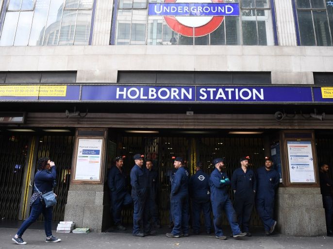 London Underground workers stand outside Holborn Station, that was temporarily closed following a fire alert, in central London Britain August 15, 2017. REUTERS/Hannah McKay