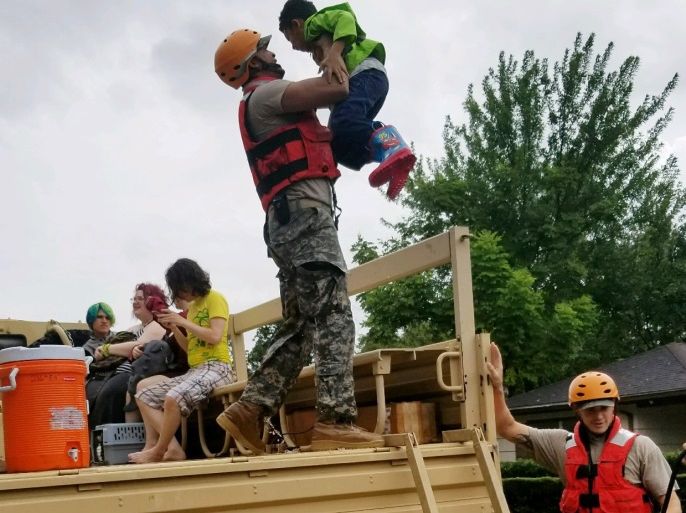 Texas National Guard soldiers aid residents in heavily flooded areas from the storms of Hurricane Harvey in Houston, Texas, U.S., August 27, 2017 Lt. Zachary West, 100th MPAD/Texas Military Department/Handout via REUTERS ATTENTION EDITORS - THIS IMAGE WAS PROVIDED BY A THIRD PARTY
