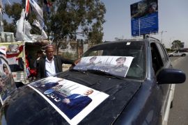 A Yemeni man sticks posters bearing the portrait of former president Ali Abdullah Saleh on his car ahead of celebrations for the 35 year anniversary of the establishment of the former president's party, General People's Congress, in the capital Sanaa on August 19, 2017. / AFP PHOTO / Mohammed HUWAIS (Photo credit should read MOHAMMED HUWAIS/AFP/Getty Images)