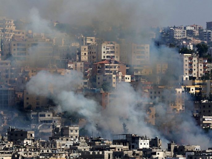 Smoke rises from buildings in Ain el-Helweh, Lebanon's largest Palestinian refugee camp, near the southern coastal city of Sidon, during clashes between Palestinian security forces and Islamist fighters on August 19, 2017. / AFP PHOTO / Mahmoud ZAYYAT (Photo credit should read MAHMOUD ZAYYAT/AFP/Getty Images)
