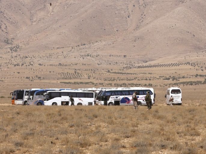 Vehicles waiting to transport Islamic State (IS) group members are seen in the Qara area in Syria's Qalamoun region on August 28, 2017 as part of a deal between Hezbollah and IS fighters where the jihadists would leave to eastern Syria.Syria's state news agency SANA, quoting a military source, confirmed Hezbollah and IS had agreed that 'the remaining Daesh (IS) fighters will leave to eastern Syria'. And a Lebanese military source told AFP the jihadist group would qu