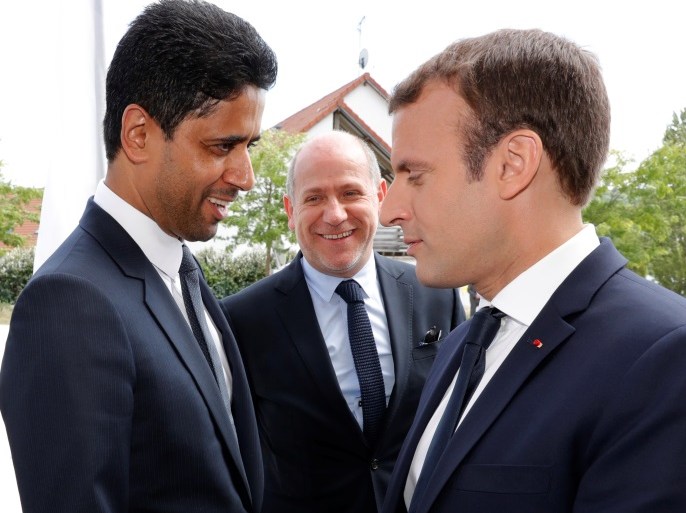 French President Emmanuel Macron talks with Paris St Germain's charmain and CEO Nasser Al-Khelaif during a visit at the recreational centre for children in Moisson, France, August 3, 2017. REUTERS/Philippe Wojazer