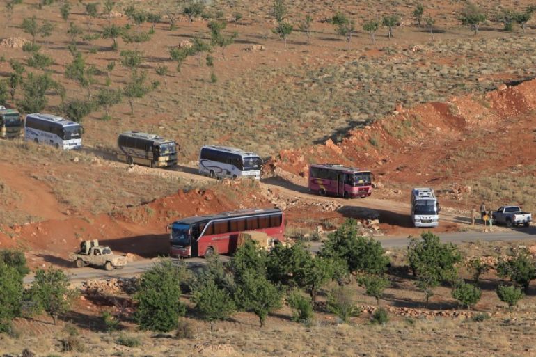 Military vehicles escort buses that will transfer Nusra Front militants in Jroud Arsal, Syria-Lebanon border, July 31, 2017. REUTERS/Ali Hashisho