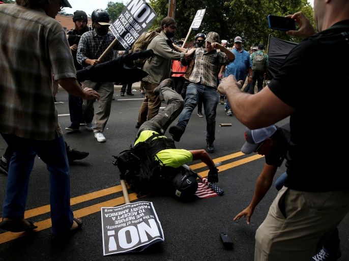 Counter demonstrators attack a white supremacist during a rally in Charlottesville, Virginia, U.S., August 12, 2017. REUTERS/Joshua Roberts