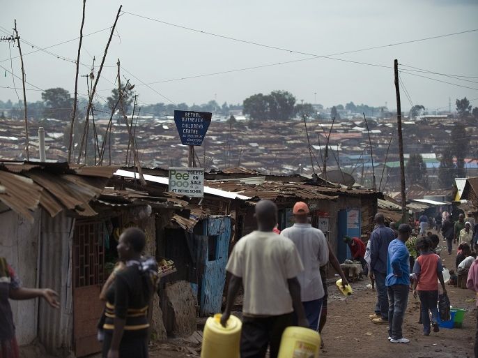 People go about their business on June 8, 2012 at Kibera slum, in Nairobi, where poor sanitation is endemic and threatens the lives of the local community. A cheap and innovative sanitation solution called 'Pee poople', which consists of a bio-degrable plastic bag pre-loaded with urea is set to change the lives of residents in slums and other informal settlements by digesting human waste quickly and hygienically thus diminishing people's contact with human excrement. Lack of proper toilets has seen numerous slum residents result to defacating outdoors in open fields or river systems greatly increasing the chances of contamination of ground water which leads to poor sanitation and the resulting diseases that claim the life of a child every 12 seconds according to research. AFP PHOTO/Tony KARUMBA (Photo credit should read TONY KARUMBA/AFP/GettyImages)