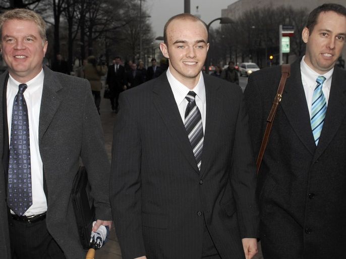 Blackwater Worldwide security guard Nick Slatten (C) and attorneys leave the federal courthouse after being arraigned with 4 fellow Blackwater guards on manslaughter charges for allegedly killing 14 unarmed civilians and wounding 20 others in a 2007 shooting in Baghdad, in Washington in this January 6, 2009 file photo. A federal judge threw out all charges on December 31, 2009 against five Blackwater Worldwide security guards accused of killing 14 Iraqi civilians in 200