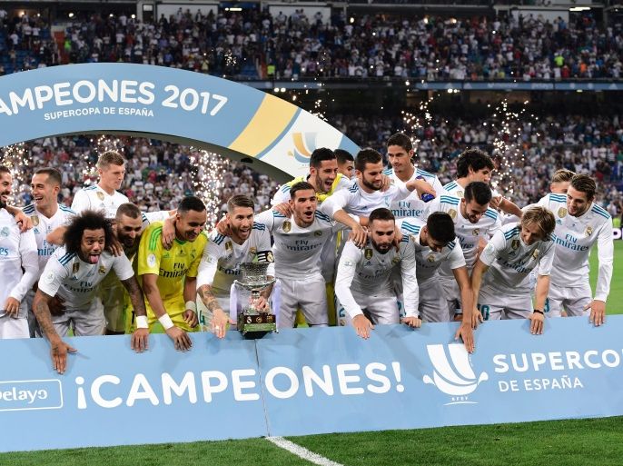 Real Madrid players celebrate their Supercup trophy after winning the second leg of the Spanish Supercup football match Real Madrid vs FC Barcelona at the Santiago Bernabeu stadium in Madrid, on August 16, 2017. / AFP PHOTO / JAVIER SORIANO (Photo credit should read JAVIER SORIANO/AFP/Getty Images)