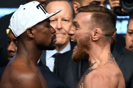 LAS VEGAS, NV - AUGUST 25: Boxer Floyd Mayweather Jr. (L) and UFC lightweight champion Conor McGregor face off during their official weigh-in at T-Mobile Arena on August 25, 2017 in Las Vegas, Nevada. The two will meet in a super welterweight boxing match at T-Mobile Arena on August 26. (Photo by Ethan Miller/Getty Images)