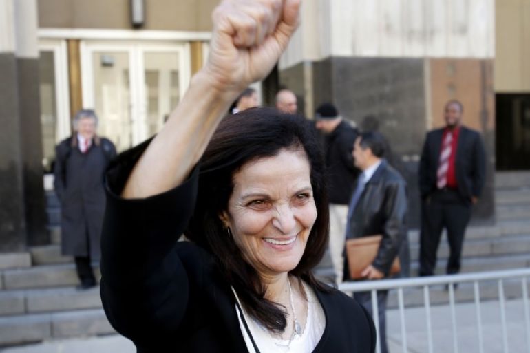Palestinian activist Rasmieh Yousef Odeh raises her fist as she leaves the federal courthouse with supporters after her sentencing in Detroit, Michigan March 12, 2015. Odeh was sentenced to 18 months in prison on Thursday for immigration fraud for failing to tell U.S. authorities that she had been imprisoned in Israel for a 1969 supermarket bombing that killed two people. REUTERS/Rebecca Cook (UNITED STATES - Tags: CRIME LAW SOCIETY IMMIGRATION)