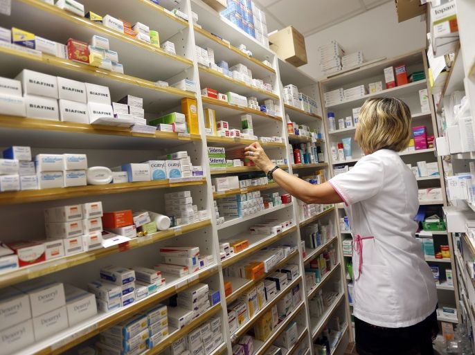 A pharmacist selects drugs inside her pharmacy in Bordeaux, France, September 15, 2015. REUTERS/Regis Duvignau
