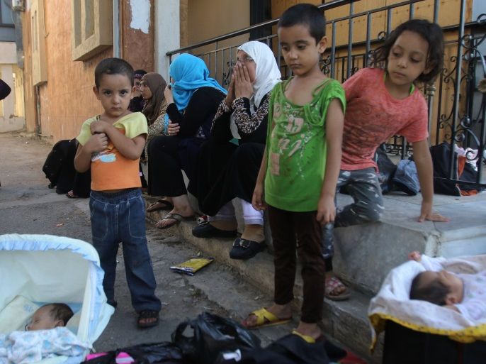 Palestinian refugees who fled the Ain al-Hilweh camp, Lebanon's largest Palestinian refugee camp, due to ongoing clashes between Palestinian security forces and Islamist fighters for the third consecutive day, are seen seeking shelter outside a mosque in the southern coastal city of Sidon on August 19, 2017.The clashes first broke out on August 17 when gunmen from the small Islamist Badr group opened fire on a position of Palestinian security forces inside the camp, a