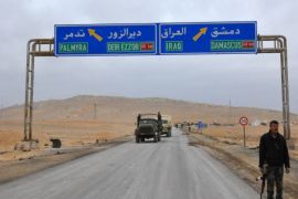 A picture taken on March 2, 2017, shows a sign displaying the routes to Palmyra-Deir Ezzor and Damascus-Iraq as Syrian regime fighters advance to retake the ancient city of Palmyra, from Islamic State (IS) group fighters. / AFP PHOTO / STRINGER (Photo credit should read STRINGER/AFP/Getty Images)