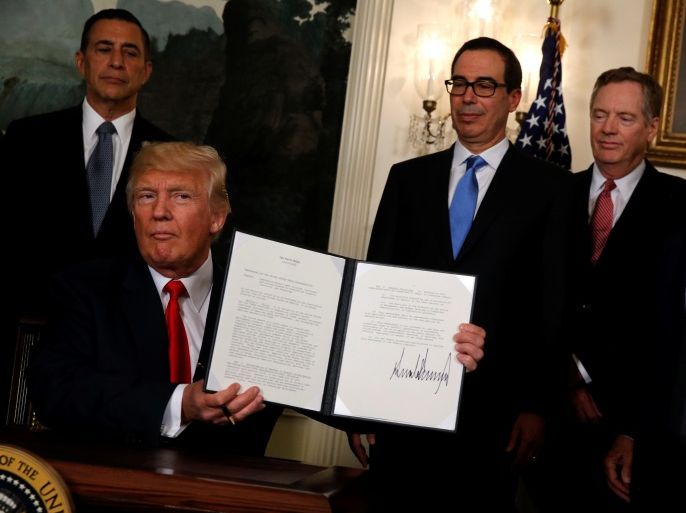 U.S. President Donald Trump, flanked by U.S. Representative Darrell Issa (R-CA) (L), Treasury Secretary Steven Mnuchin (3rd R), U.S. Trade Representative Robert Lighthizer (2nd R) and Commerce Secretary Wilbur Ross (R), finishes signing a memorandum directing the U.S. Trade Representative to complete a review of trade issues with China at the White House in Washington, U.S. August 14, 2017. REUTERS/Jonathan Ernst