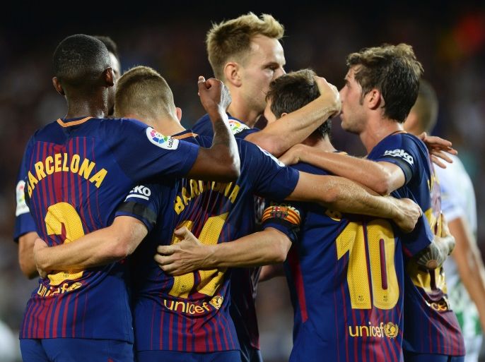 Barcelona's Argentinian forward Lionel Messi (R) celebrates with teammates after scoring during the Spanish league footbal match FC Barcelona vs Real Betis at the Camp Nou stadium in Barcelona on August 20, 2017. / AFP PHOTO / Josep LAGO (Photo credit should read JOSEP LAGO/AFP/Getty Images)
