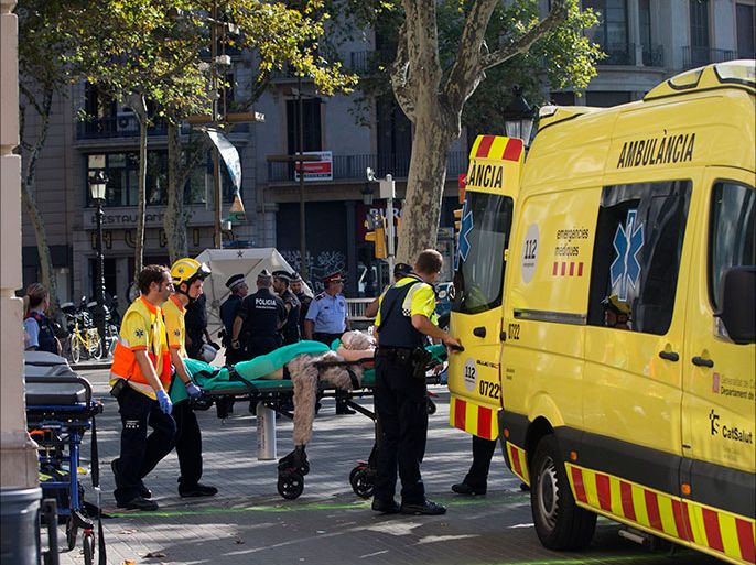 epa06148678 Mossos d'Esquadra Police officers and emergency service workers move an injured after a van crashes into pedestrians in Las Ramblas, downtown Barcelona, Spain, 17 August 2017. According to initial reports a van crashed into a crowd in Barcelona's famous Placa Catalunya square at Las Ramblas area injuring several. Local media report the van driver ran away, metro and train stations were closed. The number of people injured and the reasons behind the incident are not yet known. Official sources have not confirmed that the incident is a terrorist attack. EPA/Quique Garcia FACES PIXELATED BY SOURCE DUE TO LOCAL LAW