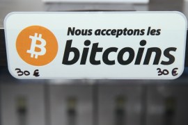 HANOVER, GERMANY - MARCH 16: A sign in French that reads: 'We accept bitcoins' hangs at a display of the LedgerWallet Nano USB stick that enables security-protected transactions with bitcoins at the 2015 CeBIT technology trade fair on March 16, 2015 in Hanover, Germany. China is this year's CeBIT partner. CeBIT is the world's largest tech fair and will be open from March 16 through March 20. (Photo by Sean Gallup/Getty Images)