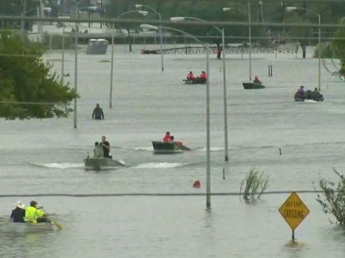 Rescue boats navigate flood waters of Tropical Storm Harvey in Port Arthur, Texas, U.S. in a still image from video August 30, 2017. REUTERS/Greg Savoy