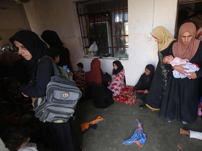 Displaced Iraqis from Tal Afar sit at a house in Al-Ayadieh village, on August 29, 2017, where some of them got injured as they were seeking shelter during the military operation against jihadists of the Islamic State group in their home town.Al-Ayadiah is the last remaining active front line near Tal Afar. / AFP PHOTO / AHMAD AL-RUBAYE (Photo credit should read AHMAD AL-RUBAYE/AFP/Getty Images)