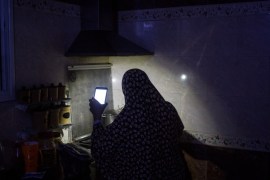 GAZA CITY, GAZA - JULY 23: Maha Zant makes tea by cell phone light at her home in the Al-Zahra district on July 23, 2017 in Gaza City, Gaza. For the past ten years Gaza residents have lived with constant power shortages, in recent years these cuts have worsened, with supply of regular power limited to four hours a day. On June 11, 2017 Israel announced a new round of cuts at the request of the Palestinian authorities and the decision was seen as an attempt by President Mahmoud Abbas to pressure Gaza's Hamas leadership. Prior to the new cuts Gaza received 150 megawatts per day, far below it's requirements of 450 megawatts. In April, Gaza's sole power station which supplied 60 megawatts shut down, after running out of fuel, the three lines from Egypt, which provided 27 megawatts are rarely operational, leaving Gaza reliant on the 125 megawatts supplied by Israel's power plant. The new cuts now restrict electricity to three hours a day severely effecting hospital patients with chronic conditions and babies on life support. During blackout hours residents use private generators, solar panels and battery operated light sources to live. June 2017 also marked ten years since Israel began a land, sea and air blockade over Gaza. Under the blockade, movement of people and goods is restricted and exports and imports of raw materials have been banned. The restrictions have virtually cut off access for Gaza's two million residents to the outside world and unemployment rates have skyrocketed forcing many people into poverty and leaving approximately 80% of the population dependent on humanitarian aid. (Photo by Chris McGrath/Getty Images)