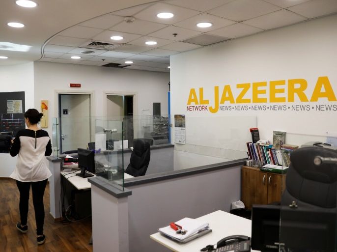 An employee walks inside an office of Qatar-based Al-Jazeera network in Jerusalem June 13, 2017. Picture taken June 13, 2017. REUTERS/Ronen Zvulun