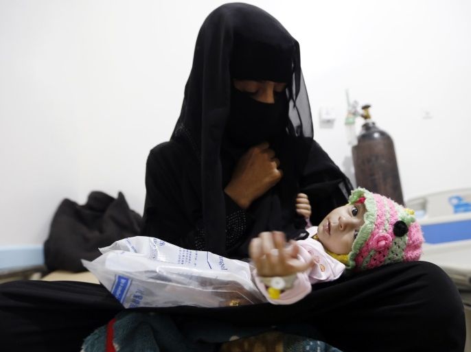A Yemeni woman holds her child, who is suspected of being infected with cholera, at a makeshift hospital in the capital Sanaa, on August 12, 2017.A cholera outbreak has claimed the lives of some 2,000 Yemenis in less than four months. / AFP PHOTO / Mohammed HUWAIS (Photo credit should read MOHAMMED HUWAIS/AFP/Getty Images)