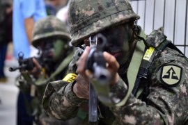 South Korean soldiers take a position during an anti-terror drill on the sidelines of South Korea-US joint military exercise, called Ulchi Freedom Guardian, at a subway station in Seoul on August 19, 2015. Tens of thousands of South Korean and US troops on August 17 began a military exercise simulating an all-out North Korean attack, as Pyongyang matched Seoul in resuming a loudspeaker propaganda campaign across their heavily-fortified border. AFP PHOTO / JUNG YEON-JE (Photo credit should read JUNG YEON-JE/AFP/Getty Images)