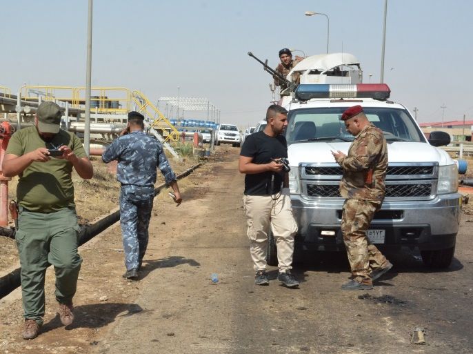 Iraqi security forces and members of the Saraya al-Salam (Peace Brigades), a group formed by Iraqi Shiite Muslim cleric Moqtada al-Sadr, inspect the site of suicide bombings at a power plant north of the capital Baghdad on September 2, 2017.Armed with grenades and wearing explosives belts, three attackers entered the facility in Samarra, about 100 kilometres (62 miles) north of the capital, at 2:00 am, an Iraqi security official told AFP, adding that the suicide bombers killed seven people and wounded 12 in the attack. / AFP PHOTO / Mahmud SALEH (Photo credit should read MAHMUD SALEH/AFP/Getty Images)
