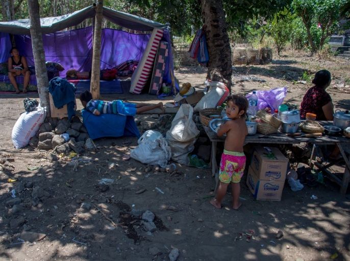 Evacuees stay at a temporary shelter in Kubu, Karangasem Regency on the Indonesian resort island of Bali on September 30, 2017.More than 144,000 people have fled from a rumbling volcano on popular tourist island Bali, but officials on September 30 urged evacuees who live outside the immediate danger zone to return home. / AFP PHOTO / BAY ISMOYO (Photo credit should read BAY ISMOYO/AFP/Getty Images)