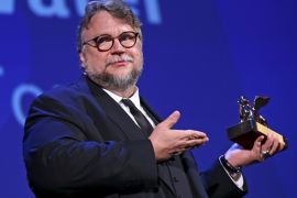 Director Guillermo Del Toro holds the Golden Lion award for the best movie