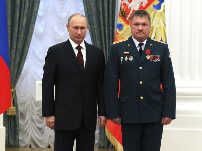 Russian President Vladimir Putin (L) stands next to General Lieutenant Valeryi Asapov, then a colonel, after decorating him with the Order of Merit to the Fatherland, fourth grade, during an awarding ceremony at the Kremlin in Moscow, Russia February 22, 2013. Picture taken February 22, 2013. Sputnik/Mikhail Klimentyev/Kremlin via REUTERS ATTENTION EDITORS - THIS IMAGE WAS PROVIDED BY A THIRD PARTY.