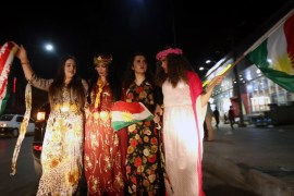 Iraqi Kurdish women wave the Kurdish flag as they celebrate the independence referendum in the streets of the northern city of Arbil on September 27, 2017 in Iraq's autonomous northern Kurdish region. Official results showed 92.73 percent of voters backing statehood in Monday's non-binding referendum, which Iraq's central government rejected as illegal. Turnout was put at 72.61 percent. / AFP PHOTO / SAFIN HAMED        (Photo credit should read SAFIN HAMED/AFP/Getty Images)