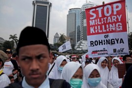 Muslim student holds poster during a protest against the treatment of the Rohingya Muslim minority by the Myanmar government, in Jakarta, Indonesia September 16, 2017. REUTERS/Beawiharta