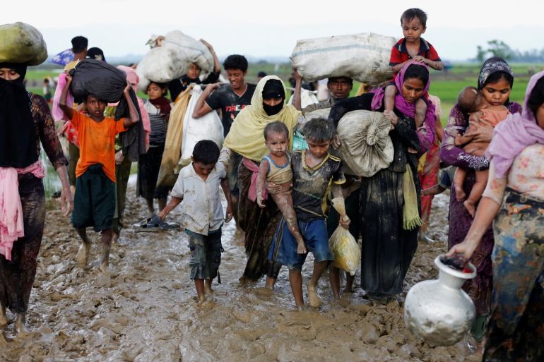 A group of Rohingya refugees walk on the muddy road after travelling over the Bangladesh-Myanmar border in Teknaf, Bangladesh, September 1, 2017. REUTERS/Mohammad Ponir Hossain