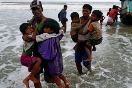 Rohingya refugee children are carried to the shore after crossing the Bangladesh-Myanmar border by boat through the Bay of Bengal in Teknaf, Bangladesh, September 7, 2017. REUTERS/Danish Siddiqui