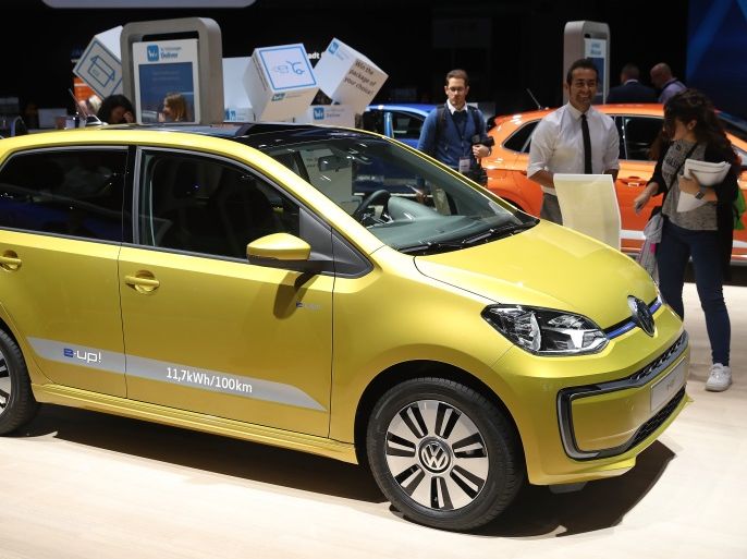 FRANKFURT AM MAIN, GERMANY - SEPTEMBER 12: Visitors look at a Volkswagen e-Up! electric car at the 2017 Frankfurt Auto Show on September 12, 2017 in Frankfurt am Main, Germany. The Frankfurt Auto Show is taking place during a turbulent period for the auto industry. Leading companies have been rocked by the self-inflicted diesel emissions scandal. At the same time the industry is on the verge of a new era as automakers commit themselves more and more to a future that wi