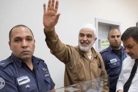 Arab-Israeli Sheikh Raed Salah (C), leader of the radical northern branch of the Islamic Movement in Israel, smiles as he arrives at the Israeli Rishon Lezion Justice court, near Tel Aviv, on August 15, 2017.Israeli police arrested a firebrand Islamic cleric who has been repeatedly accused of inciting violence over a sensitive Jerusalem holy site where tensions again flared last month. / AFP PHOTO / JACK GUEZ (Photo credit should read JACK GUEZ/AFP/Getty Images)
