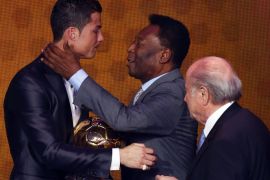 Portugal's Cristiano Ronaldo is congratulated by Pele as FIFA President Sepp Blatter (R) looks on after being awarded the FIFA Ballon d'Or 2013 in Zurich January 13, 2014. Portugal and Real Madrid forward Cristiano Ronaldo was named the world's best footballer for the second time on Monday, preventing his great rival Lionel Messi from winning the award for a fifth year in a row. REUTERS/Arnd Wiegmann (SWITZERLAND - Tags: SPORT SOCCER)