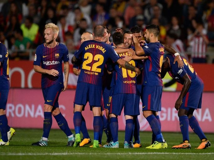 Barcelona players celebrate after scoring during the Spanish league football match Girona FC vs FC Barcelona at the Montilivi stadium in Girona on September 23, 2017. / AFP PHOTO / Josep LAGO (Photo credit should read JOSEP LAGO/AFP/Getty Images)