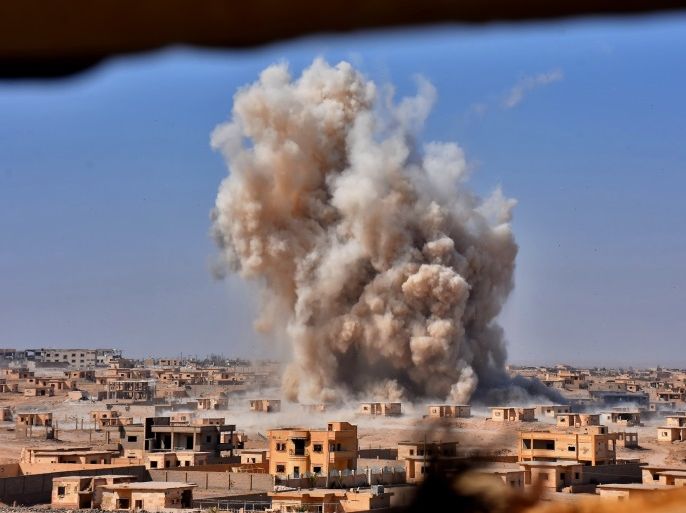 TOPSHOT - Smoke rises from buildings in the area of Bughayliyah, on the northern outskirts of Deir Ezzor on September 13, 2017, as Syrian forces advance during their ongoing battle against the Islamic State (IS) group. After breaking an Islamic State group blockade, Syria's army is seeking to encircle the remaining jihadist-held parts of Deir Ezzor city, a military source. / AFP PHOTO / George OURFALIAN (Photo credit should read GEORGE OURFALIAN/AFP/Getty Images)