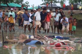 EDITORS NOTE: Graphic content / Bangladeshi onlookers stand next to bodies washed up on the banks of the Naf river in Tenkaf on September 1, 2017.The United Nations has said the number of Rohingya Muslims to flee violence in Myanmar in recent days has topped 27,000, as corpses of the displaced on September 1 washed up on Bangladeshi soil. A further 20,000 Rohingya have massed along the Bangladeshi border, the UN added in statement late August 31, but are barred from ent